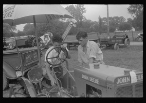 Examining tractor on display at county fair, central Ohio.2