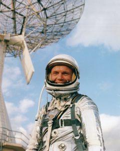 John Glenn posing in front of the radar dish at Cape Canaveral, Florida in 1962