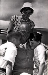 Marine Major New Speed King, July 17, 1957. Major Glenn embraces children while wife Ann looks on