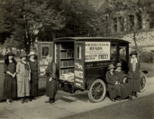 Black and white photograph of seven women gathered around a mobile library.