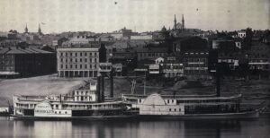 1848 Cincinnati riverfront lined with businesses, tops of buildings in distance, and Ohio river and steamboats in foreground