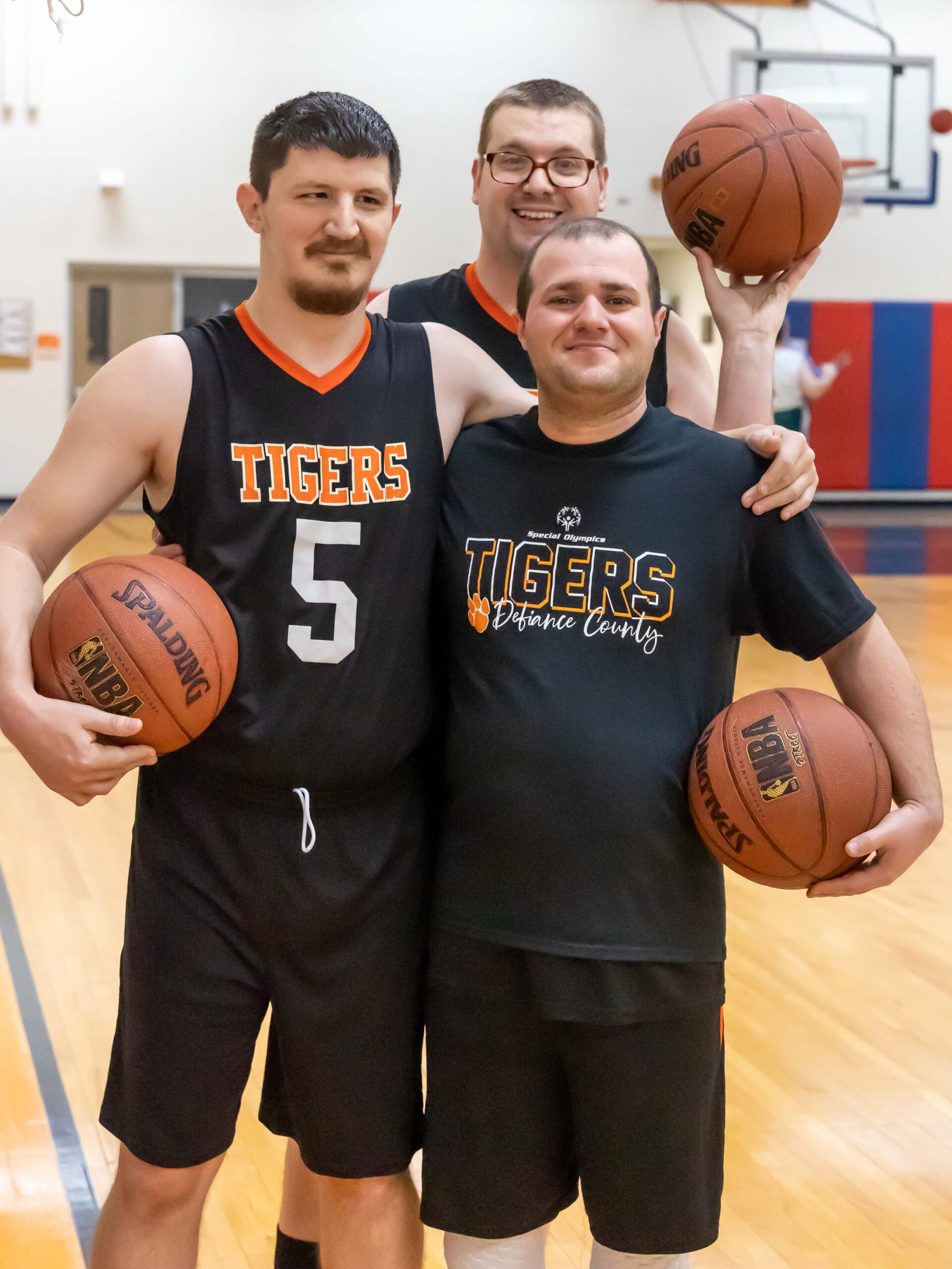 two men holding basketballs