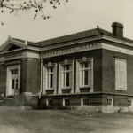 Black and white photograph of a brick building.