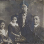 Black and white photograph of 4 people: 2 adults and 2 children.