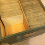 A photograph of an open green drawer filled with card. The cards have writing on them.